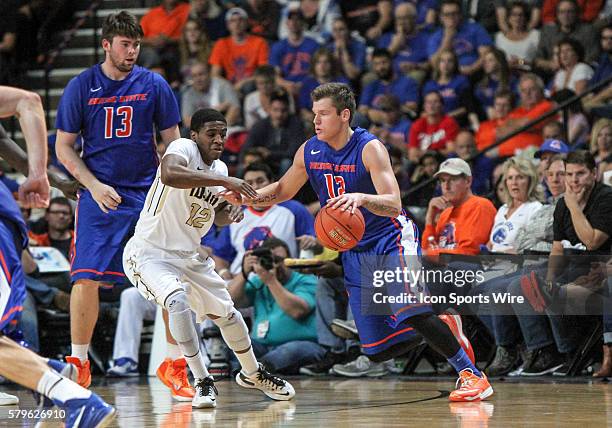 Boise State Broncos guard Igor Hadziomerovic drives around Idaho Vandals guard Mike Scott during 2nd half action between the Boise State Broncos and...