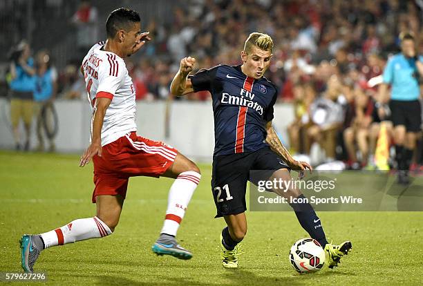 Paris St. Germain midfielder Lucas Digne moves the ball past a challenge from Benfica defender Andre Almeida in the second half of an International...