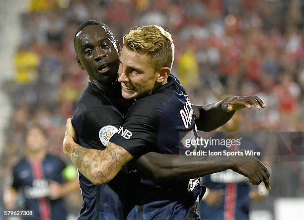 Paris St. Germain midfielder Lucas Digne is greeted by forward Jean-Kevin Augustin after scoring the winning goal in a 3-2 win over Benfica in an...
