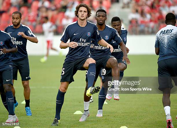 Paris St. Germain midfielder Adrien Rabiot leads team mates in warm up drills before playing Benfica in an International Champions Cup game at BMO...
