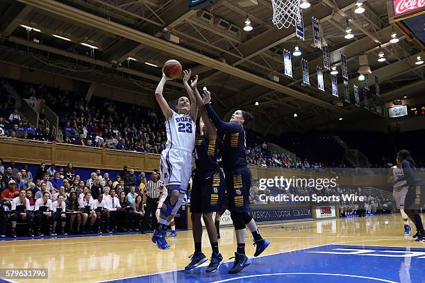 Duke's Rebecca Greenwell shoots over Marquette's Arlesia Morse and Chelsie Butler . The Duke University Blue Devils hosted the Marquette University...