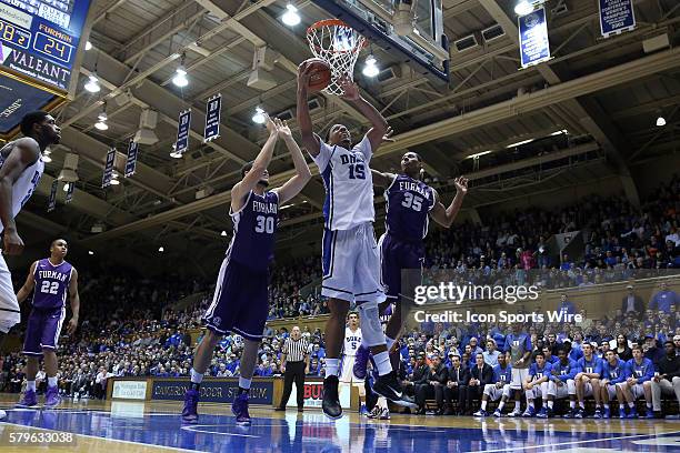 Duke's Jahlil Okafor shoots over Furman's Kendrec Ferrara and Daniel Fowler . The Duke University Blue Devils hosted the Furman University Paladins...