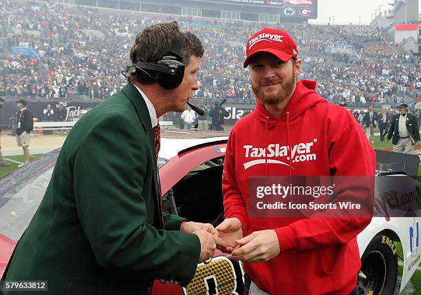 Dale Earnhardt, Jr. Drive of the TaxSlayer Hendrick Motorsports Chevrolet in Sprint Cup Series delivers the coin for the coin toss before the...