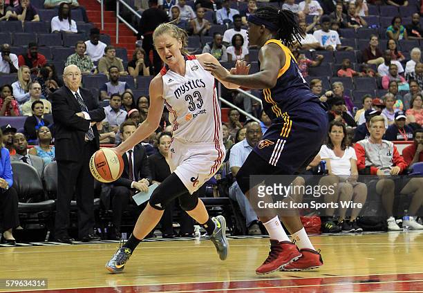 Emma Meesseman of the Washington Mystics dribbles past Lynetta Kizer of the Indiana Fever during a WNBA game at Verizon Center, in Washington D.C....
