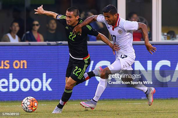 Mexico defender Paul Aguilar battles Costa Rica forward Johan Venegas during the second half of the CONCACAF Gold Cup quarterfinal game between the...