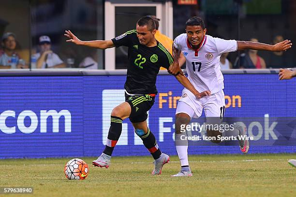 Mexico defender Paul Aguilar battles Costa Rica forward Johan Venegas during the second half of the CONCACAF Gold Cup quarterfinal game between the...