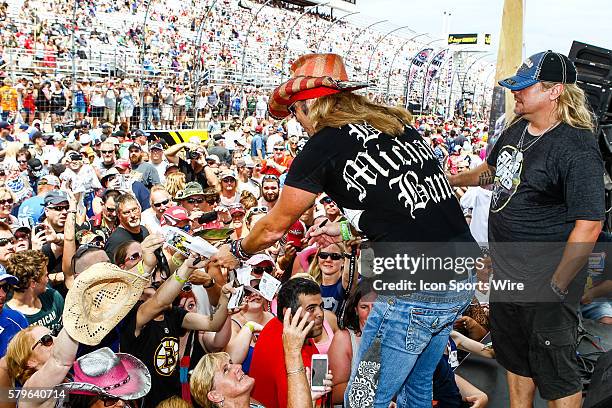 The Bret Michaels signs autographs for fans prior to the start of the 5-hour ENERGY 301 at New Hampshire Motor Speedway in Loudon, NH.