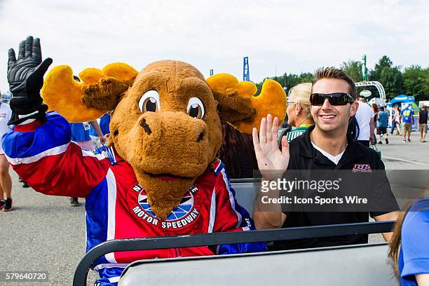 Sprint Cup driver, Matt DiBenedetto, driver of the Burger King Toyota and Milo the Moose wave to fan as they make their way to the Fan Zone prior to...