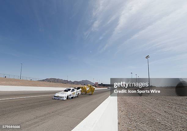 John Force Chevrolet Camaro NHRA Funny Car deploys his drag racing parachute during the 16th Annual SummitRacing.com NHRA Nationals at The Strip at...