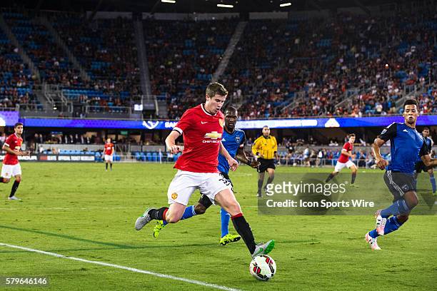 Manchester United midfielder Patrick McNair brings the ball into the area as San Jose Earthquakes forward Quincy Amarikwa defends, during the...