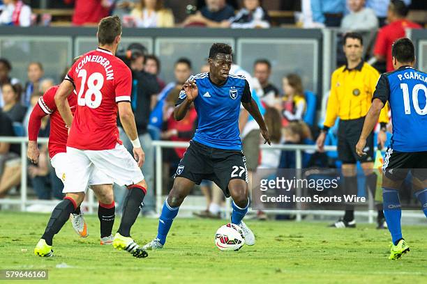 San Jose Earthquakes midfielder Fatai Alashe drives down the wing as Manchester United midfielder Morgan Schniderlein defends, during the...