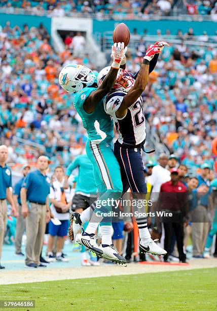 Miami Dolphins Wide Receiver DeVante Parker leaps in the air to juggle the ball and then finally make the reception as New England Patriots...
