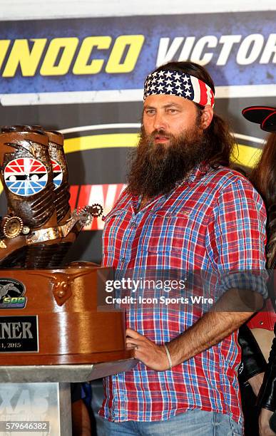 Willie Robertson waits to present the trophy to the winner of the NASCAR Sprint Cup Series Duck Commander 500 at Texas Motor Speedway in Ft. Worth,...