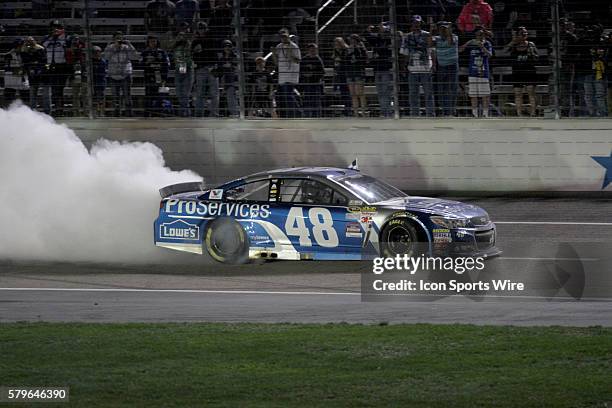 Jimmie Johnson, driver of the Lowes Pro Services Chevy celebrates winning the NASCAR Sprint Cup Series Duck Commander 500 at Texas Motor Speedway in...