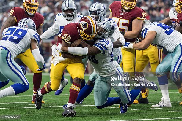 Washington Redskins running back Alfred Morris gets tackled by Dallas Cowboys middle linebacker Anthony Hitchens during the game between the Dallas...