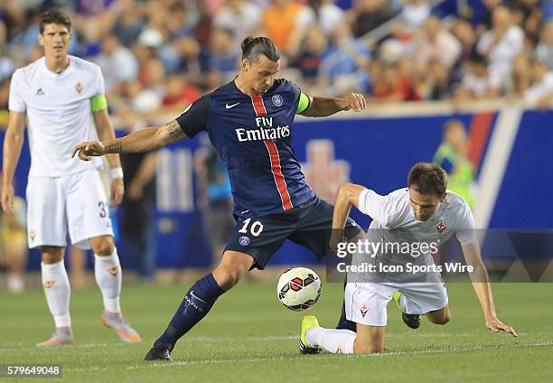 Zlatan Ibrahimovic of Paris Saint Germain gets the ball from Milan Badelj of Fiorentina during a 2015 International Champions Cup match at Red Bull...