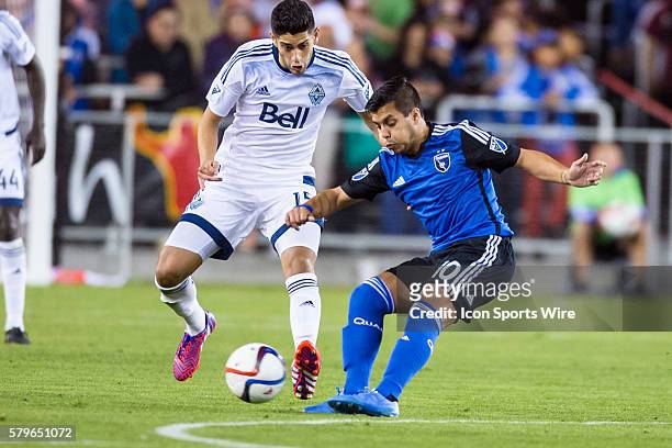 San Jose Earthquakes midfielder Matias Perez Garcia passes the ball past Vancouver FC midfielder Matias Laba , during an MLS soccer game between the...