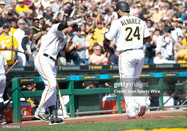 Pittsburgh Pirates first baseman Pedro Alvarez is greeted by shortstop Jordy Mercer after hitting a solo home run during the seventh inning in the...