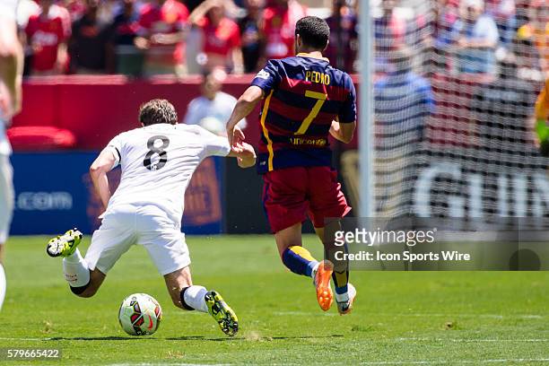 Manchester United forward Juan Mata is fouled by Barcelona forward Pedro Rodriguez Ledesma , during the International Champions Cup game between...