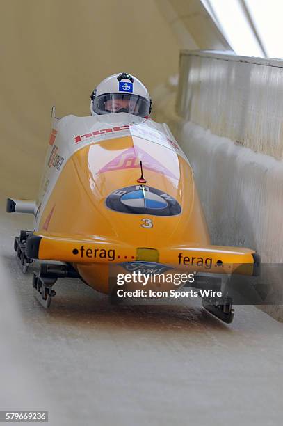 The Swiss sled with driver Rico Peter with brakeman Janne Bror van der Zijde slides on the track at the Olympic Sports Complex in Lake Placid, NY in...