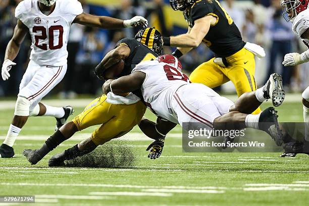 Missouri Tigers running back Marcus Murphy is pulled down by a mid air diving Alabama Crimson Tide defensive lineman A'Shawn Robinson during the...