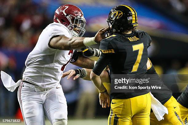 Missouri Tigers quarterback Maty Mauk gets popped in the face maske just after releasing a pass by Alabama Crimson Tide linebacker Ryan Anderson...