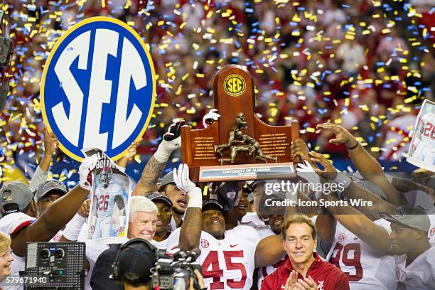 Alabama Crimson Tide running back Jalston Fowler holds up the SEC Championship trophy along with head coach Nick Saban and teammates in the Alabama...