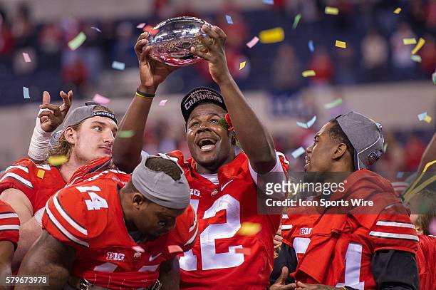 Ohio State Buckeyes quarterback Cardale Jones holds the Big Ten Championship trophy after the NCAA Big 10 Championship football game between the...