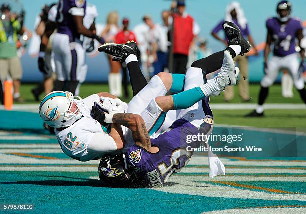 Miami Dolphins Wide Receiver Brian Hartline catches a pass in the endzone for a touchdown with Baltimore Ravens Cornerback Asa Jackson during the NFL...