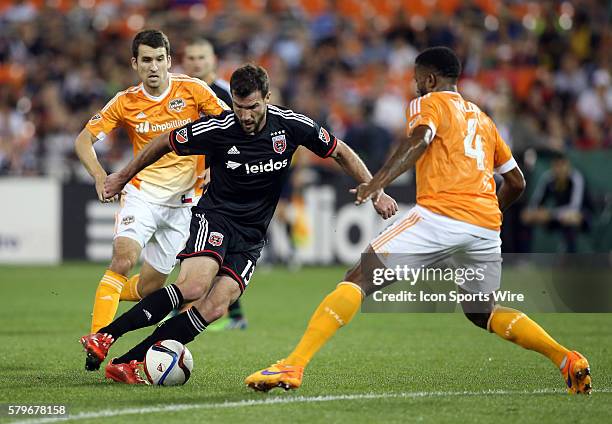 United midfielder/forward Chris Pontius dribbles towards Houston Dynamo defender Jermaine Taylor during a MLS match at RFK Stadium, in Washington...