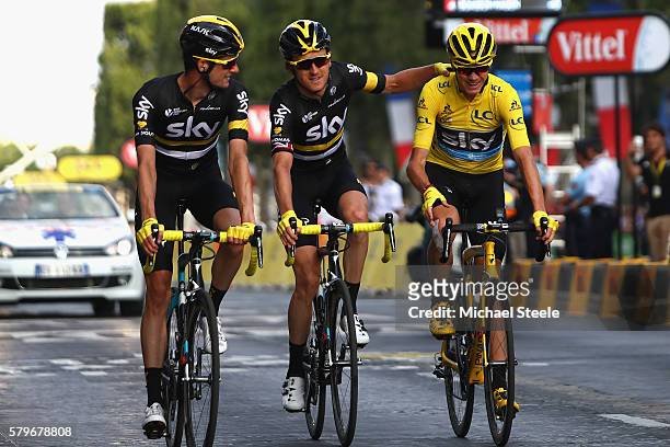 Geraint Thomas of Great Britain and Team Sky and Wout Poels of the Netherlands and Team Sky congratulate Chris Froome of Great Britain and Team Sky...