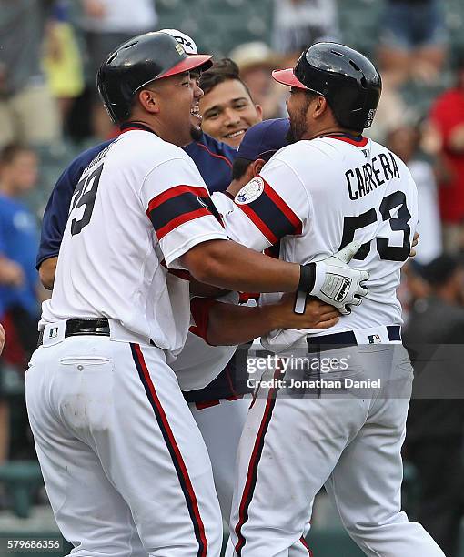 White Sox players including Jose Abreu mob Melkey Cabrera after he got the game-winning hit, a single in the 9th inning, against the Detroit Tigers...