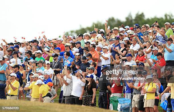 The crowd cheers for Jared du Toit of Canada as he walks up the 18th fairway during the final round of the RBC Canadian Open at Glen Abbey Golf Club...