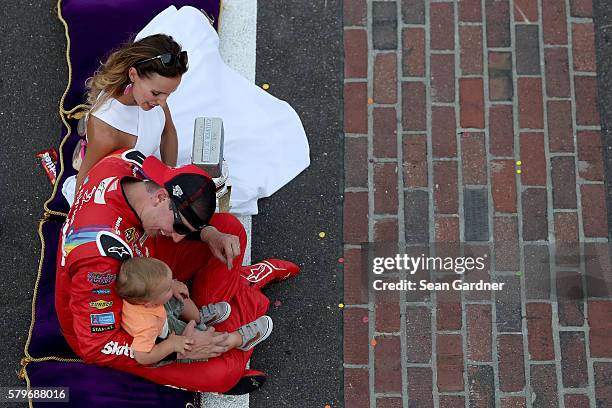 Kyle Busch, driver of the Skittles Toyota, celebrates with his wife, Samantha, and son, Brexton, after winning the NASCAR Sprint Cup Series Crown...