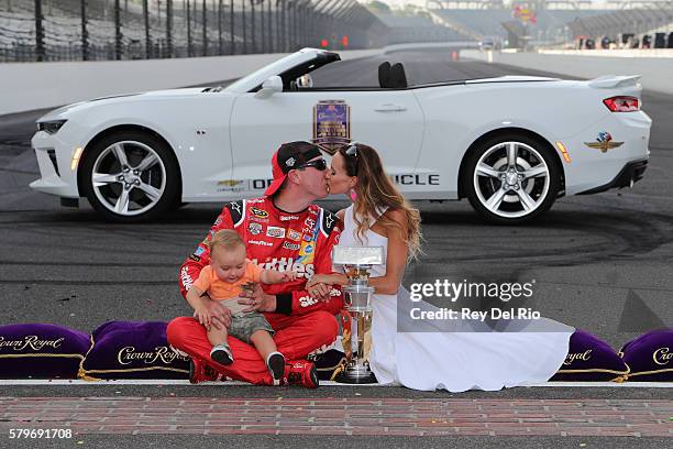 Kyle Busch, driver of the Skittles Toyota, poses with his wife, Samantha, and son, Brexton, after winning the NASCAR Sprint Cup Series Crown Royal...