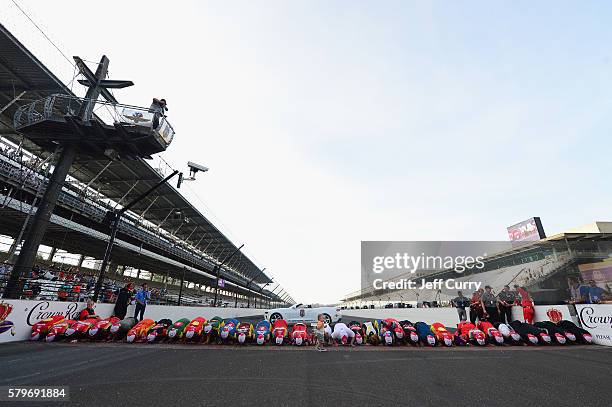 Kyle Busch, driver of the Skittles Toyota, kisses the bricks with his wife, Samantha, after winning the NASCAR Sprint Cup Series Crown Royal Presents...