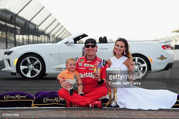 Kyle Busch, driver of the Skittles Toyota, celebrates with his wife, Samantha, after winning the NASCAR Sprint Cup Series Crown Royal Presents the...
