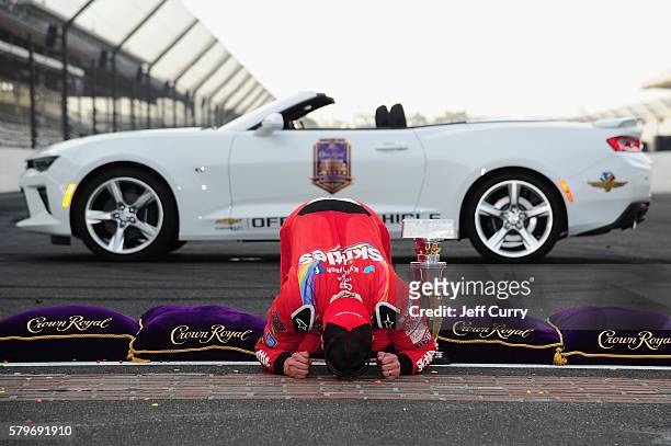 Kyle Busch, driver of the Skittles Toyota, kisses the bricks after winning the NASCAR Sprint Cup Series Crown Royal Presents the Combat Wounded...