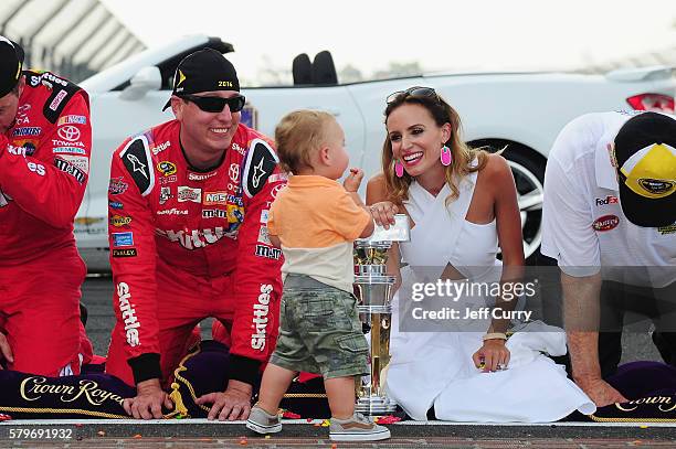 Kyle Busch, driver of the Skittles Toyota, poses with his wife, Samantha, and son, Brexton, after winning the NASCAR Sprint Cup Series Crown Royal...
