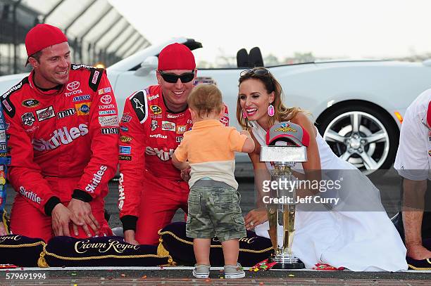 Kyle Busch, driver of the Skittles Toyota, celebrates with his wife, Samantha, and son, Brexton, after winning the NASCAR Sprint Cup Series Crown...