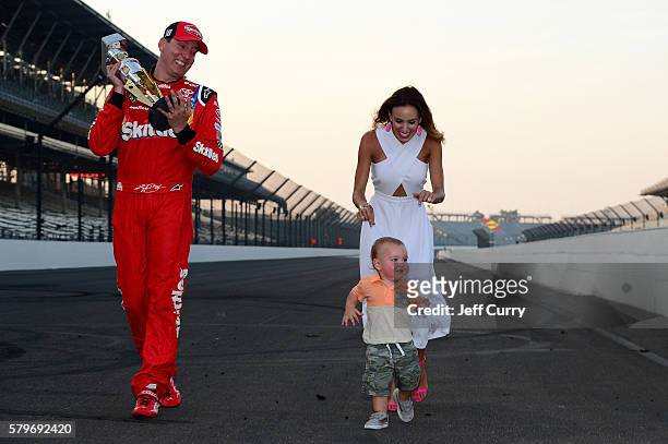 Kyle Busch, driver of the Skittles Toyota, celebrates with his wife, Samantha, and son, Brexton, after winning the NASCAR Sprint Cup Series Crown...