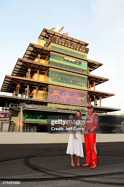 Kyle Busch, driver of the Skittles Toyota, poses with his wife, Samantha, and son, Brexton, after winning the NASCAR Sprint Cup Series Crown Royal...