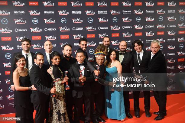 Colombian Ciro Guerra holds his award for Best Director for the film "Embrace of the Serpent" with crew members during the Platino Ibero-American...