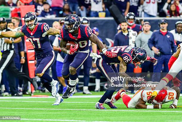 Houston Texans running back Alfred Blue hurdles Kansas City Chiefs linebacker Justin Houston enroute to a long first half gain during the Chiefs at...