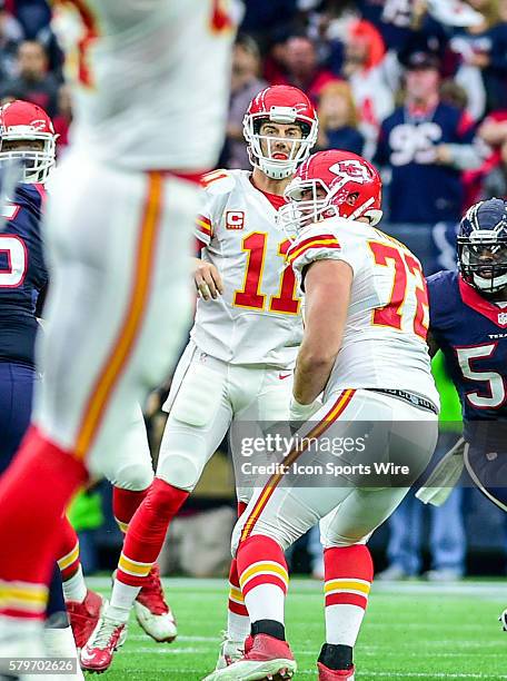 Kansas City Chiefs quarterback Alex Smith watches intently as Kansas City Chiefs tight end Travis Kelce extends for a first half reception during the...