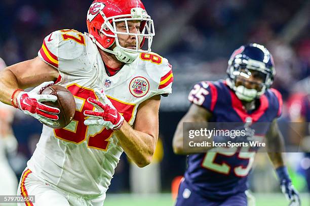 Kansas City Chiefs tight end Travis Kelce sprints for a moderate gain after a first half reception as Houston Texans defensive back Kareem Jackson...