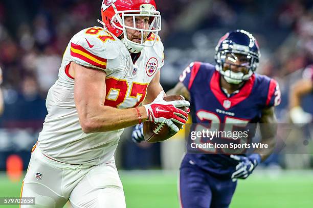 Kansas City Chiefs tight end Travis Kelce sprints for a moderate gain after a first half reception as Houston Texans defensive back Kareem Jackson...