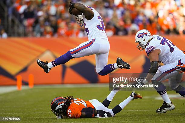 Buffalo Bills running back Bryce Brown hurdles Denver Broncos cornerback Bradley Roby as he runs with the ball. The Denver Broncos defeated the...