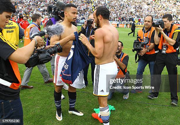 Los Angeles Galaxy forward Landon Donavon and New England Revolution Charlie Davies exchange shirts at the end of the 2014 MLS Cup at StubHub Center,...
