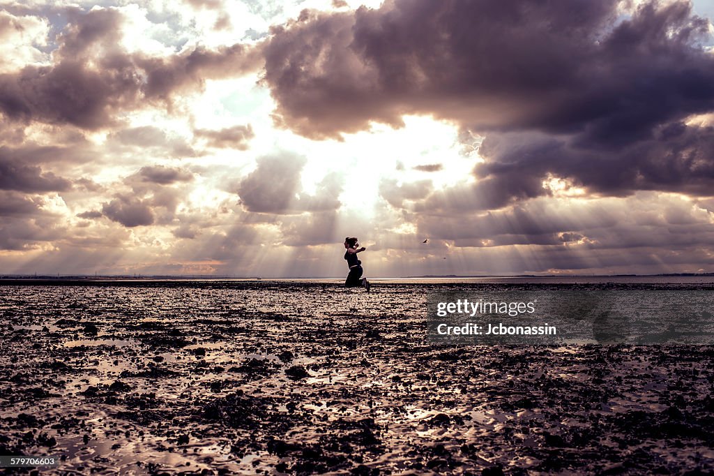 Woman jumping on the beach